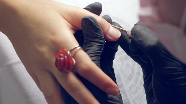 Manicure process. Correction of female nails with drilling machine