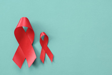 red ribbons on blue background, hiv awareness concept, world AIDS day, world hypertension day, world cancer day - obrazy, fototapety, plakaty