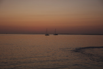 Fototapeta na wymiar NB__8750 Sunset with anchored sailboats off Ilha Culatra Portugal