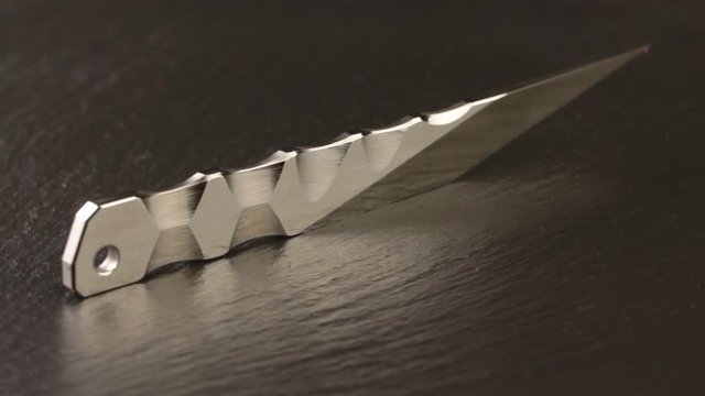 Custom hand crafted japanese kiridashi knife on the turning slate board table