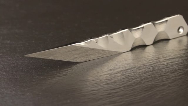 Custom hand crafted japanese kiridashi knife on the turning slate board table