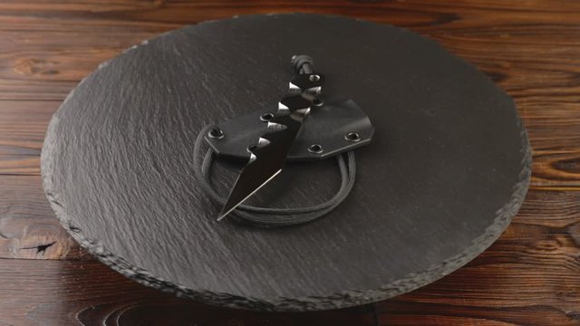 Custom hand crafted japanese kiridashi knife on the turning slate board table