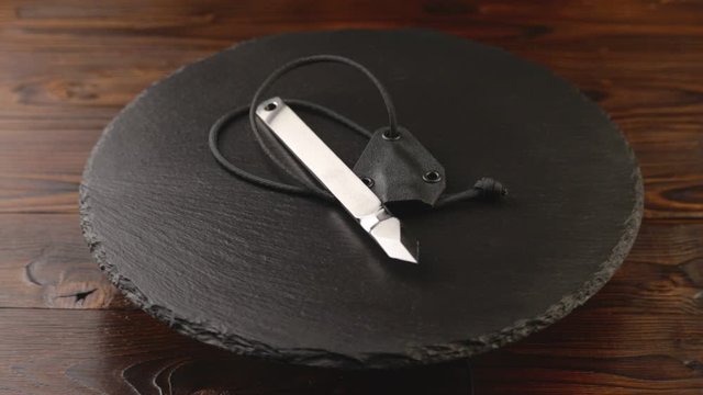 Custom hand crafted japanese kiridashi marking knife for carpenter on the turning slate board table. Polished surface