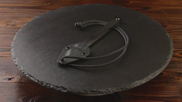 Custom hand crafted japanese kiridashi marking knife for carpenter on the turning slate board table. Polished surface