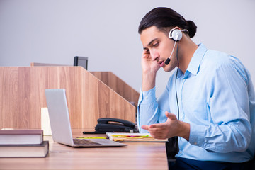 Call center operator working at his desk