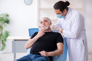 Old man visiting young doctor for plastic surgery
