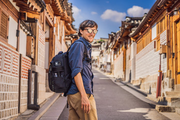 Obraz na płótnie Canvas Young man tourist in Bukchon Hanok Village is one of the famous place for Korean traditional houses have been preserved. Travel to Korea Concept
