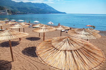 tropical beach with hay umbrellas