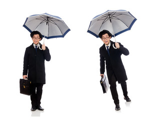 Young man holding suitcase and umbrella isolated on white