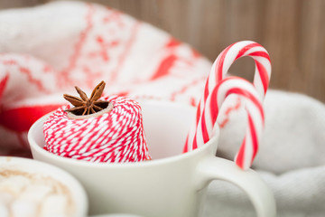 Christmas background, warm sweater, candies and spices. Winter background