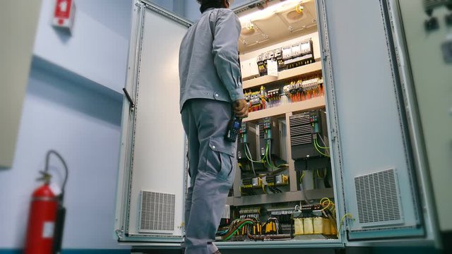 Engineer to check electrical control cabinet in substation building