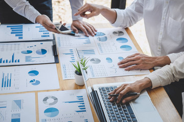 Business casual team manager having a discussion with new project success financial statistics,...