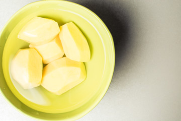 Peeled new potatoes in deep dish with water to remove nitrites.