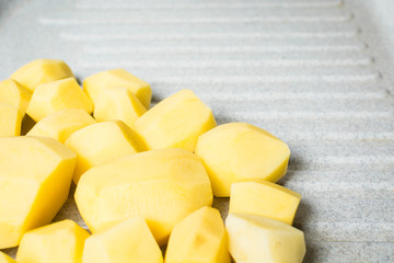 Peeled new potatoes on the sink.