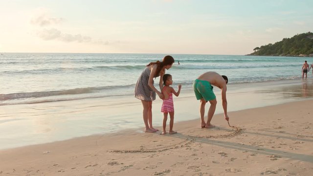 Happy young family having fun on beach,4K