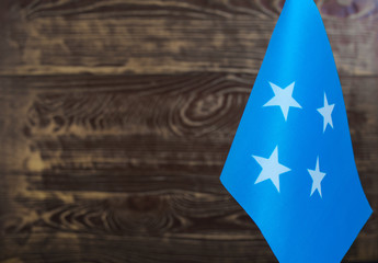 Fragment of the flag of the Federated States of Micronesia in the foreground blurred background copy space