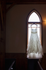 Wedding Dress Hanging in Church Window