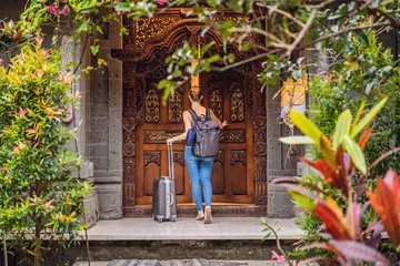 Fotobehang Young beautiful woman check in authentic hotel in Bali. Tourism Bali Concept © galitskaya