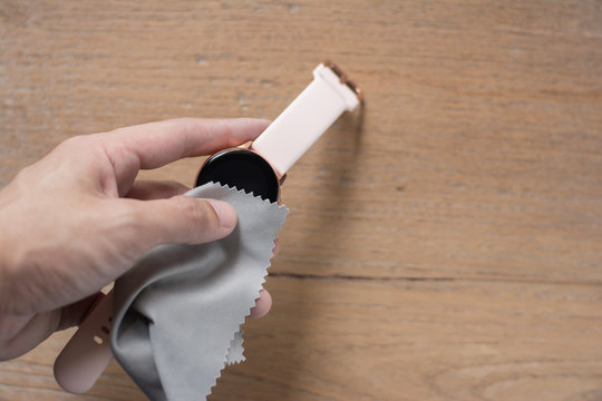 Close up cleaning modern smart watch with microfiber cloth and Cleaner cream concept.Cleaning modern watch by Cleaner cream.Cleaning stainless steel by Cleaner cream,Cleaning leather by Cleaner cream,