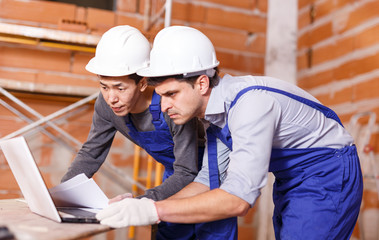 Professional builders using laptop