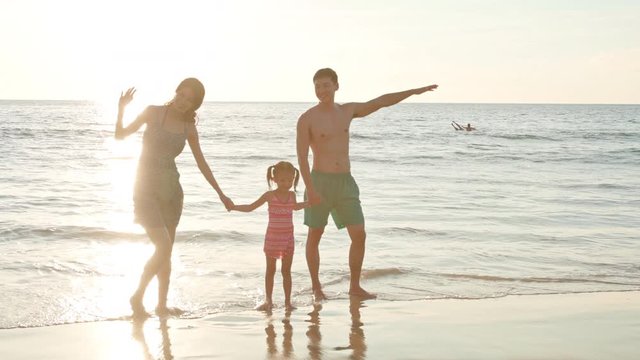 Happy young family enjoying vacation on beach,4K