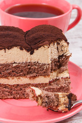 Creamy tiramisu cake with different layers and black coffee. Delicious dessert for celebrations