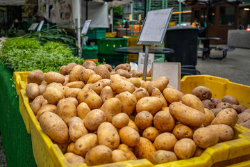 Potatoes pile at an open air farmers market stall