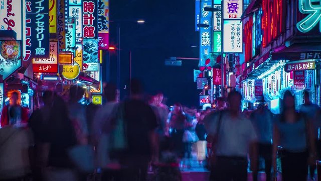 A night timelapse of the neon street at the downtown in Shinjuku Tokyo long shot tilt