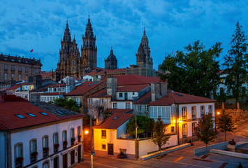 Fototapeta na wymiar Santiago de Compostela Cathedral Spectacular View by Night Dusk with Street Lights and Tiled Roofs La Coruña Galicia