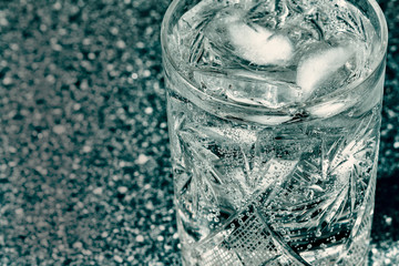 Glass of sparkling water with ice