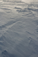 Cold, natural texture. Snow, crust, crust, windy weather. Grey, white colour, background. Winter, loneliness. Slanting Lines, geometry.