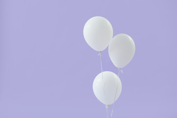 White balloons on color background