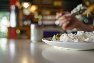 Eating Thai stir fried pork with rice