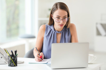 Young woman working on laptop in office