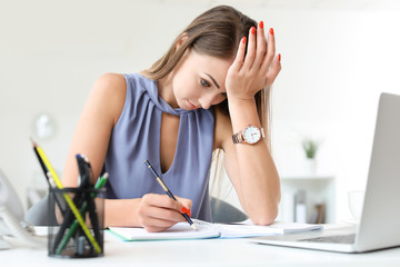 Young woman trying to meet deadline in office