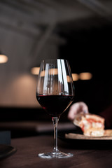 Glass of red wine on wooden table