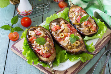 Thanksgiving Autumn Menu. Baked Stuffed Eggplant with Olives, Feta Cheese and Vegetables on a Rustic Table.