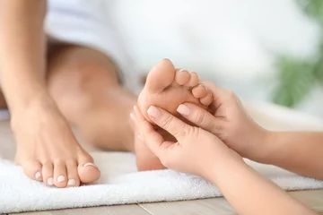 Keuken foto achterwand Beautiful young woman receiving foot massage in spa salon © Pixel-Shot
