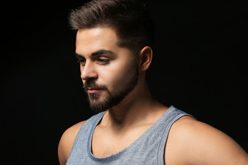 Sporty young man on dark background