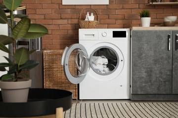 Interior of kitchen with modern washing machine