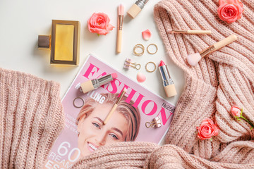Obraz na płótnie Canvas Fashion magazine, warm scarf, cosmetics and accessories on table
