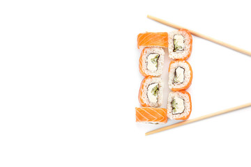 Tasty sushi rolls and chopsticks on white background
