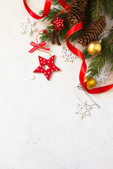 Christmas, new year concept background. Xmas composition. Branches of spruce and red decorations. Top view flat lay background. Copy space.