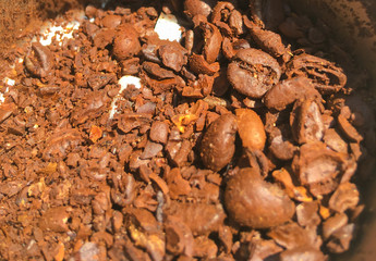 The fried coffee beans lie in a coffee grinder. Arab coffee is prayed in a mechanical grinder. Morning coffee.