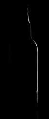 silhouette of bottle on black background