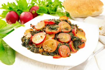 Radish with spinach and spices in plate on table