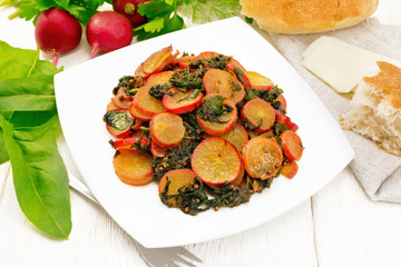 Radish with spinach and spices in plate on white board