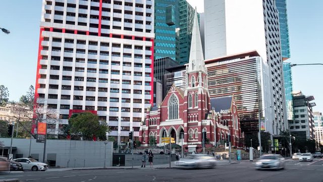 Red brick church set against modern buildings in Brisbane