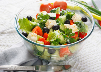Salad of fresh vegetables and cheese on  served table