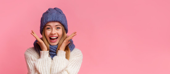 Excited young woman in winter clothes seeing shocking news